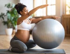 Pregnant woman doing prenatal exercise with a stability ball